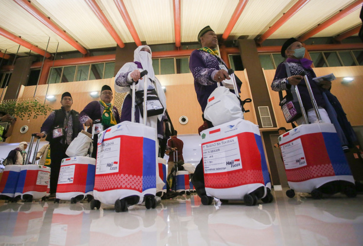 Leading the way: Haj pilgrims walk to the departure terminal at the Soekarno-Hatta International Airport in Tangerang, Banten, on Thursday, ahead of their flights to Prince Mohammad bin Abdulaziz International Airport in Medina, Saudi Arabia. Nearly 400 pilgrims from Jakarta are the first group of pilgrims to fly to Saudi Arabia, marking the start of the 2025 haj season for more than 200,000 Indonesian pilgrims.