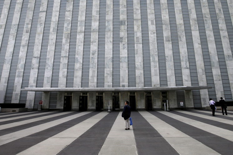 A man pauses outside the entrance to the Assembly Building at the United Nations headquarters in New York City, September 21, 2015. 