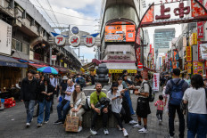 People visit the Ameya-Yokocho in Ueno, one of the busiest open-air markets in Tokyo during the Golden Week holiday on April 30, 2024.