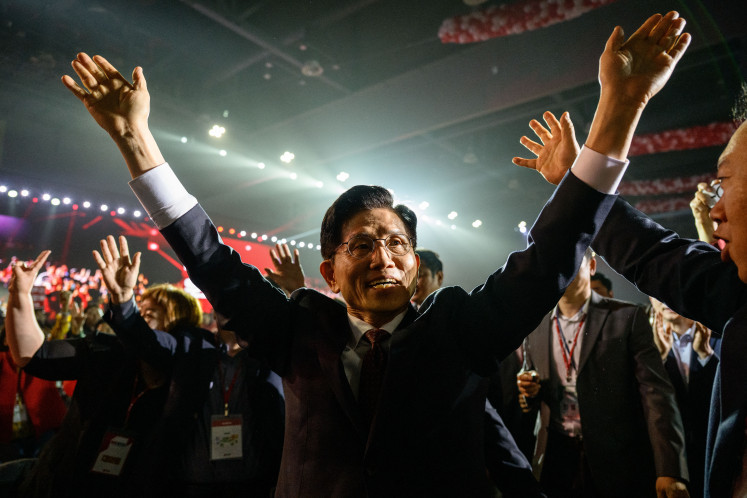 Former labor minister Kim Moon-soo (center) arrives at a party national convention to choose South Korea's conservative People Power Party's (PPP) candidate for the upcoming presidential election in Goyang on May 3, 2025.