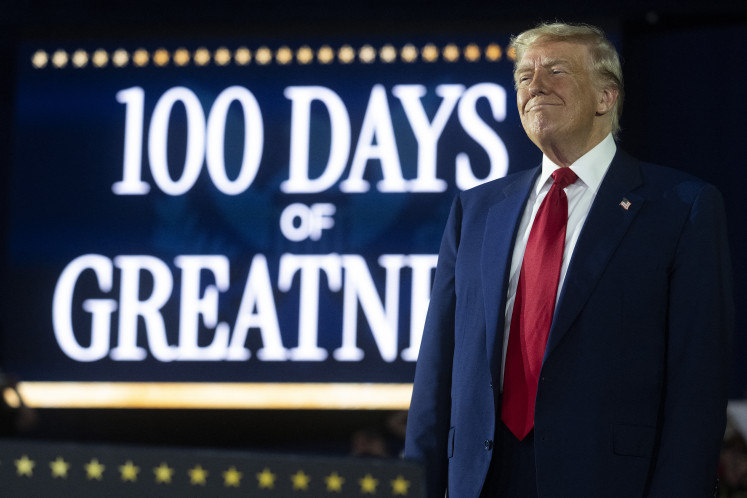 United States President Donald Trump delivers a speech  on April 29 marking his 100th day in office at Macomb County Community College Sports Expo Center in Warren, Michigan.