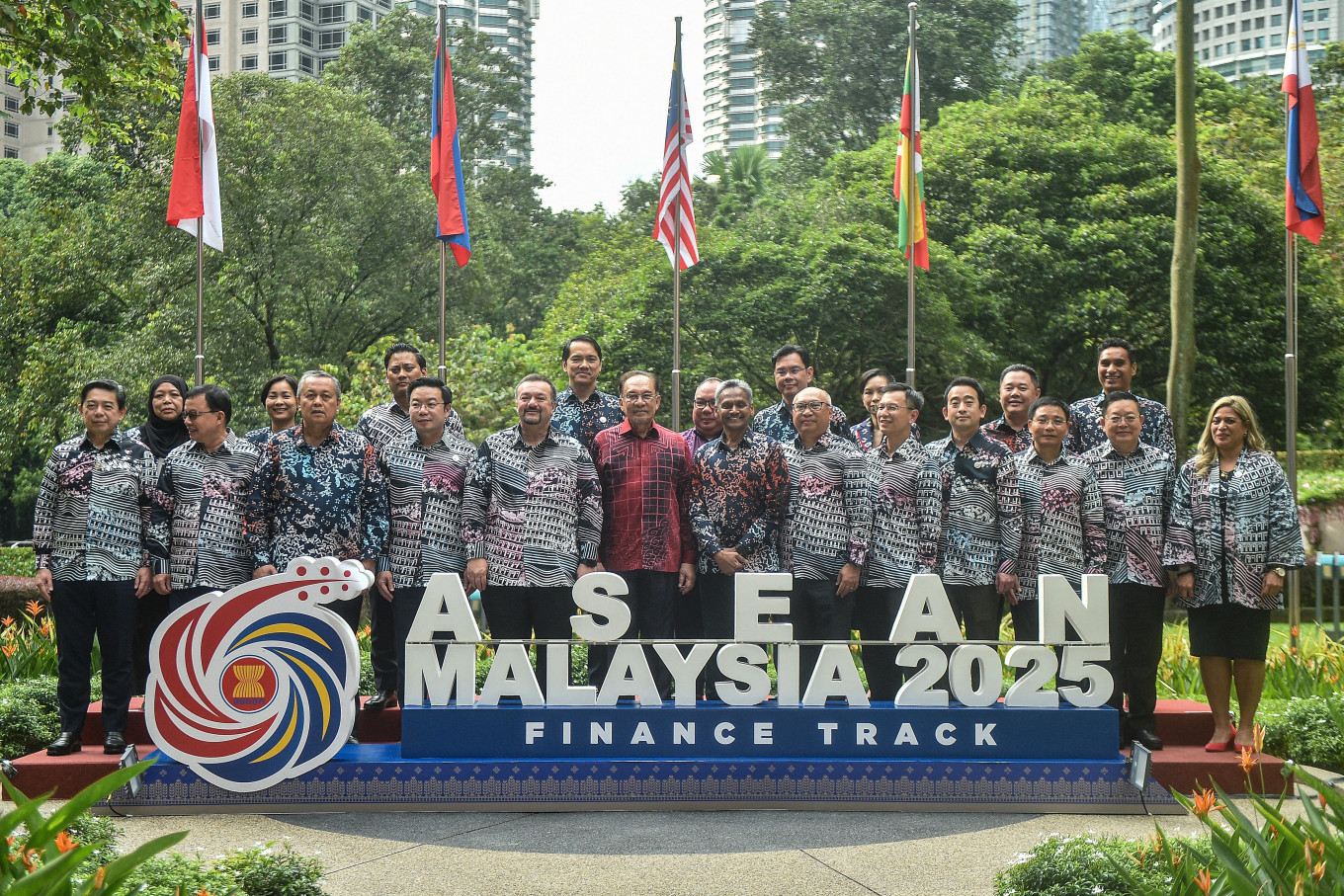 Malaysia's Prime Minister Anwar Ibrahim (center) poses for a group photo with ASEAN finance ministers and bank governors on April 10, the last day of the 12th ASEAN Finance Ministers and Bank Governors meeting in Kuala Lumpur.