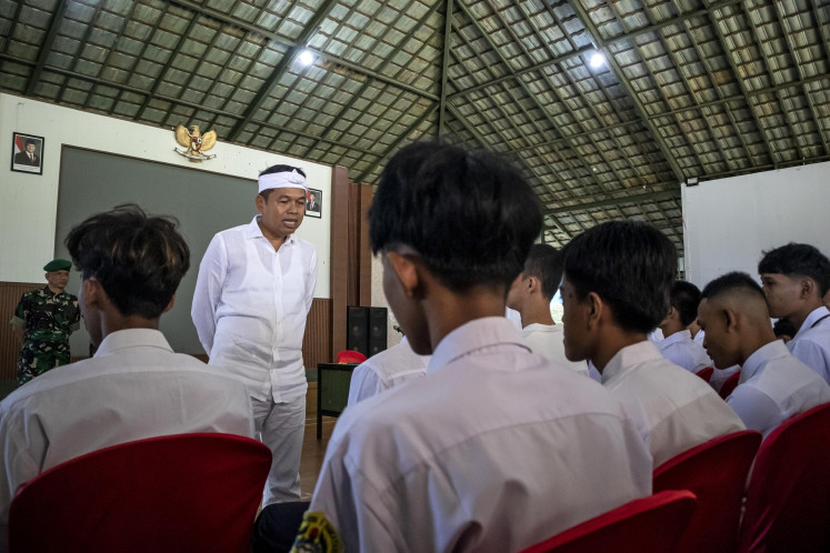 West Java governor Dedi Mulyadi (third left) talks with some students when inspecting a character and discipline training at a military education in West Bandung regency, West Java on May 5, 2025. Hundreds of students from various regions across West Java who are found of involved in street brawls, motorbike gangs and addicted to online games undergo an intensive training led by Indonesian Military (TNI) personnel for at least 14 days.
