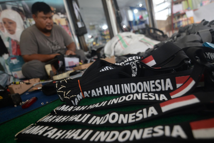 A worker replaces a strap on a bag for haj pilgrims on Tuesday at the Donohudan haj dormitory in Boyolali, Central Java.