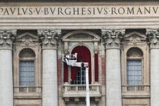 A worker operates on a crane for preparations of the main central loggia balcony of the St Peter's Basilica where the name of the new pope will be announced and where he will give the Urbi and orbi at The Vatican, on May 5, 2025. 