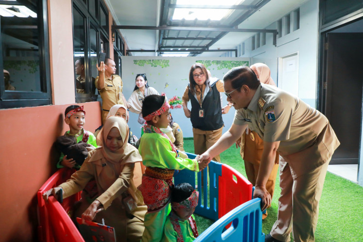 Jakarta Governor Pramono Anung (right) holds the hand of a student at Prosperous Children’s Park (TAS) Arutala in Kebon Bawang, North Jakarta, on May 5, 2025. The governor launched the free preschool program to fulfill his campaign promise of providing better access to early childhood education in the capital.