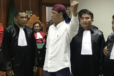 Hercules Rozario Marshal, (center) appears in the West Jakarta District Court on Feb. 27. 