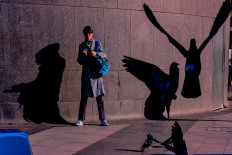 Shadow painting: A photo entitled ‘Dancing Shadows: A Pigeon' Reverie’ by Indian photographer Mithu Chakraborty captures a fascinating interplay of light and shadow. The work is among photographs at display in the ‘Seen by Her’ street photo exhibition in Jakarta. Courtesy of Mithu Chakraborty