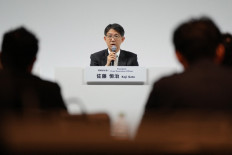 Toyota Motor President and CEO Koji Sato (center) answers questions during a press briefing for the company's financial results in Tokyo on May 8, 2025. 
