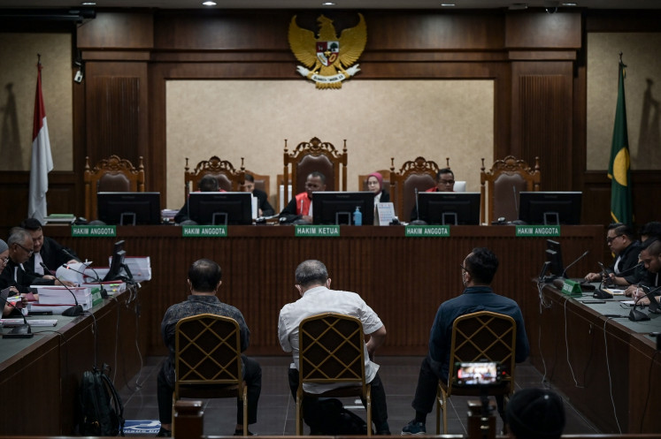 Justice at last: Three judges standing trial in a bribery case pertaining to the acquittal of a former lawmaker's son in a murder case in Surabaya, East Java, namely, (from left to right) Erintuah Damanik, Mangapul and Heru Hanindyo, listen to the prosecutor's sentencing demands during a hearing at the Jakarta Corruption Court on April 22, in Jakarta. The court sentenced Erintuah and Mangapul to seven years in prison, and Heru to 10 years, in a hearing on May 8, after finding them guilty of accepting bribes in exchange for a favorable ruling in the murder case.