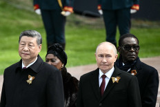Russian President Vladimir Putin and foreign leaders, including Chinese President Xi Jinping, attend a ceremony to lay flowers at the Tomb of the Unknown Soldier by the Kremlin wall in central Moscow on May 9, 2025. 