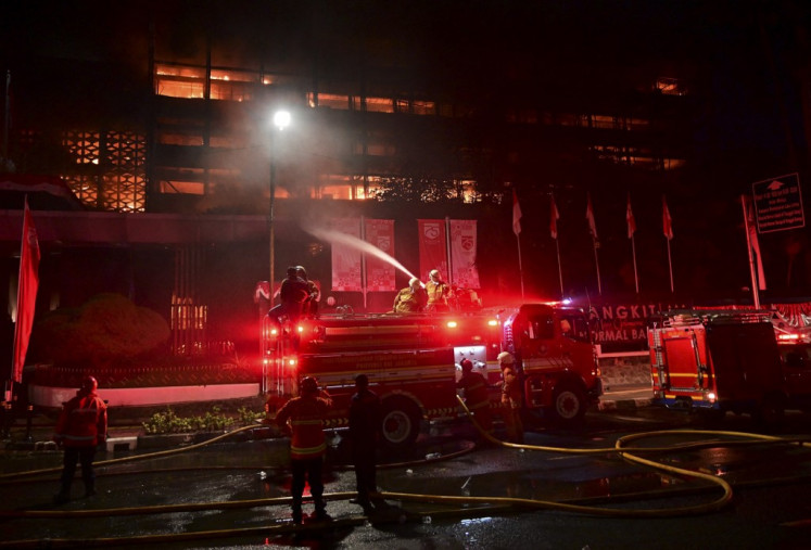 Firefighters douse a fire at the Attorney General's Office (AGO) building in Jakarta on Aug. 22, 2020.