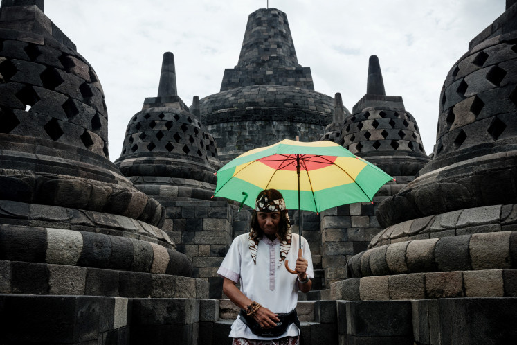 A tour guide stands at Borobudur Temple, the world's largest Buddhist monument and a UNESCO World Heritage Site, on Jan. 31, in Magelang, Central Java.