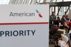 People from the first group of white South Africans granted refugee status for being deemed victims of racial discrimination under US President Trump's Refugee plan, check in for a connecting flight, at Dulles International Airport, in Dulles, Virginia, US, May 12, 2025. 