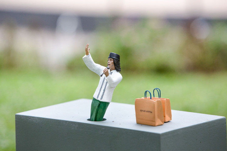 Golong-Golongan by Wiyoga Muhardanto juxtaposes figurines representing sectors of the Indonesian working class with symbols of luxury labels.