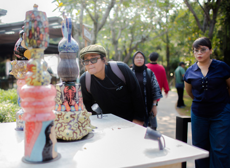 Visitors examine totemic sculptures by husband-and-wife duo Sekarputi and Agugn, iincluding The Guardian of Nature, The Culture Protectors and Emotional Safeguard.