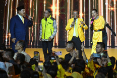 President Prabowo Subianto (left), accompanied by Golkar Party chairman Bahlil Lahadalia (second right) and some singers, performs a song on Dec.12, 2024, during an event commemorating the Golkar Party's 60th anniversary in Sentul, Bogor, West Java. (Antara/Aditya Pradana Putra)