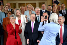 Australia's Governor General Sam Mostyn shows a selfie to Australia's re-elected Prime Minister Anthony Albanese (center) and his cabinet members after a swearing-in ceremony at Government House in Canberra on May 13, 2025.