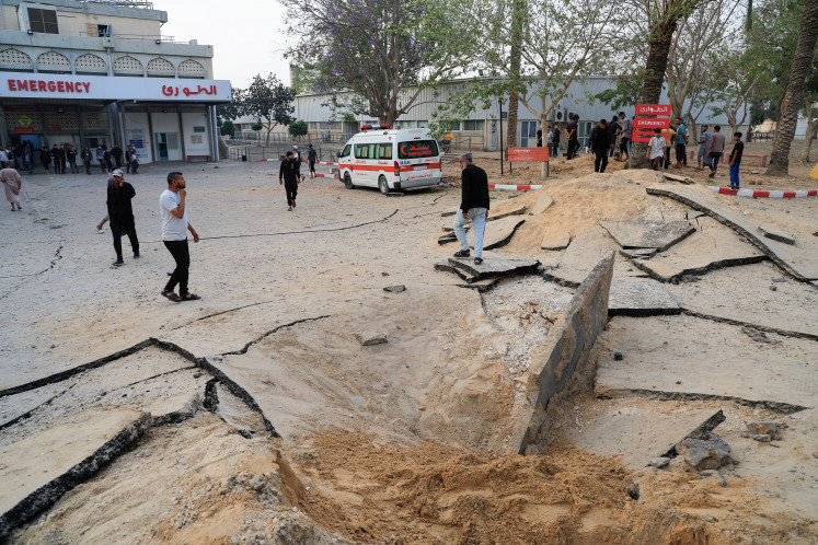 Palestinians inspect the damage at the European Hospital, which was partially damaged following Israeli airstrikes, according to the Gaza Health Ministry, in Khan Younis, in the southern Gaza Strip, May 13, 2025.