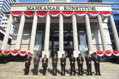 Constitutional Court Chief Justice Suhartoyo (center) accompanied by constitutional judges (from left to right) Arsul Sani, Daniel Yusmic Pancastaki Foekh, Enny Nurbaningsih, Saldi Isra, Anwar Usman, Arief Hidayat, M. Guntur Hamzah and Ridwan Mansyur take a group photo in front of the constitutional pillars after attending the commemoration ceremony of the 21st Anniversary of the Constitutional Court at the Constitutional Court Building, Jakarta, on Tuesday, June 13, 2024. Chairman of the Constitutional Court Suhartoyo in his mandate said the level of public trust and the image of his institution was getting better, especially after deciding the dispute over the results of the 2024 presidential and legislative elections. 