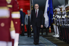 Australia's Prime Minister Anthony Albanese (center) inspects a guard of honor upon his arrival at the Halim Perdanakusuma Air Base in Jakarta on May 14, 2025, on his first overseas visit after being re-elected.