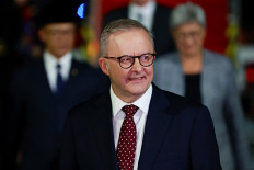 Australian Prime Minister Anthony Albanese smiles reacts upon his arrival at the Halim Perdanakusuma Air Base in Jakarta on May 14, 2025, on his first overseas visit after being re-elected.