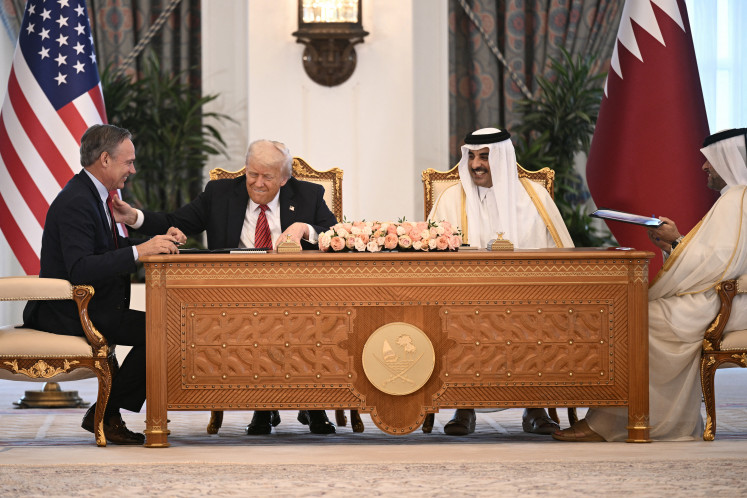 Boeing CEO Kelly Ortberg sits to the left of US President Donal Trump and Qatar's Emir Sheikh Tamim bin Hamad al-Thani (right) during a business deal signing ceremony at the Royal Palace in Doha, on May 14, 2025. Trump touched down at Hamad International Airport in Doha, with relations between the two governments in the spotlight over Qatar's offer to Trump of a US$400 million luxury aircraft to serve as a new Air Force One and then pass into his personal use.
