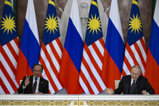 Russian President Vladimir Putin and Malaysia's Prime Minister Anwar Ibrahim deliver a joint media statement following their talks at the Kremlin in Moscow on May 14, 2025.