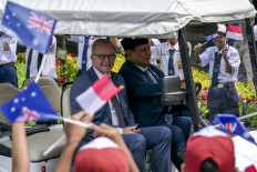 President Prabowo Subianto (right) drives a golf cart with Australian Prime Minister Anthony Albanese after a joint press conference at the State Palace in Jakarta on May 15, 2025.