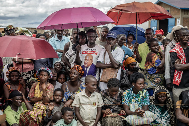 Congolese refugees gather for a possible chance to receive aid during a food distribution operation on May 7 at the Musenyi refugee site in Giharo. Since January 2025, more than 71,000 people fleeing ongoing violence in the eastern part of the Democratic Republic of Congo have crossed into Burundi, its largest refugee influx in decades, the United Nations says. 