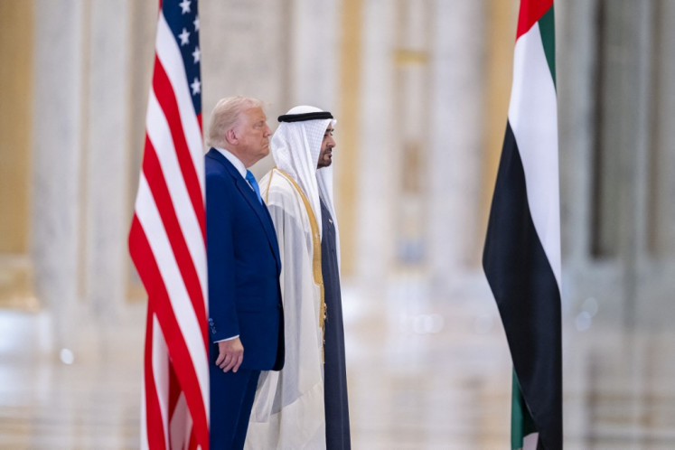 This handout picture released by the UAE Presidential Courth shows US President Donald Trump (left) and his UAE counterpart Sheikh Mohamed bin Zayed Al Nahyan standing for the national anthems at Qasr Al-Watan (Palace of the Nation) in Abu Dhabi on May 15, 2025. 