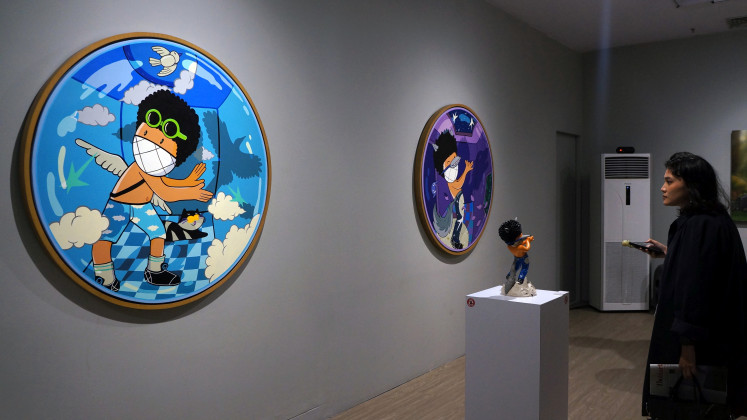 Shadow play: A visitor observes Teguh “Gula” Septian Arifianto’s artworks at The Knight’s Dreams exhibition at the JPLive! Space in The Jakarta Post’s building, Jakarta, on May 15, 2025. Gula drew inspiration for his works from wayang, the traditional Indonesian shadow puppet theater.