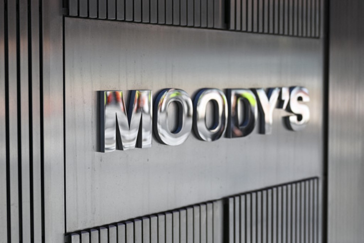 Signage for Moody's Corporation is displayed at their headquarters at 7 World Trade Center on March 18, 2025, in New York City, United States.