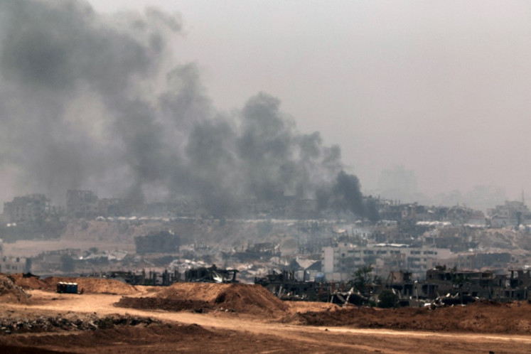 This picture taken from a position in southern Israel on the border with the Gaza Strip shows smoke billowing in Gaza during Israeli bombardment on May 17, 2025. The Israeli military announced the early stages of an intensified operation in Gaza aimed at defeating Hamas.