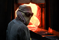 A worker oversees a production line on April 30, 2025, at a steel factory in Lahore, Pakistan.