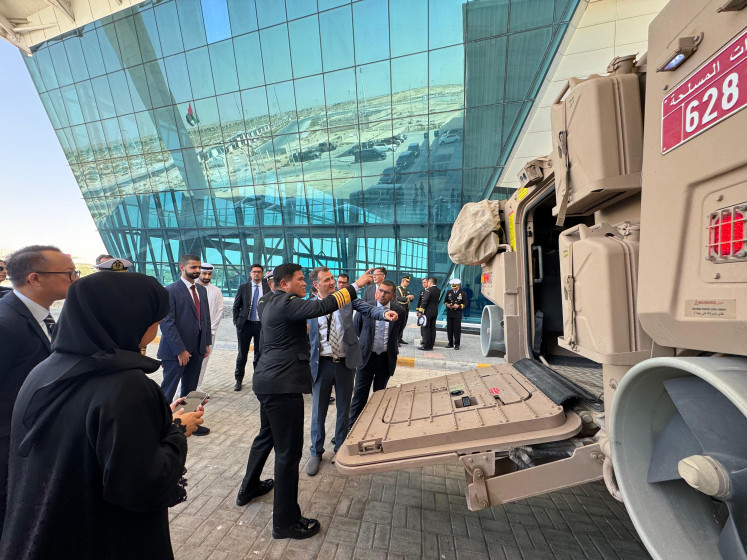 Indonesian Navy chief of staff Adm. Muhammad Ali (center left) points to the rear hatch of the Rabdan 8x8 amphibious wheeled armored combat vehicle at the headquarters of Emirati advanced technology and defense conglomerate Edge Group in Abu Dhabi. Ali visited the UAE on May 15-16, 2025.