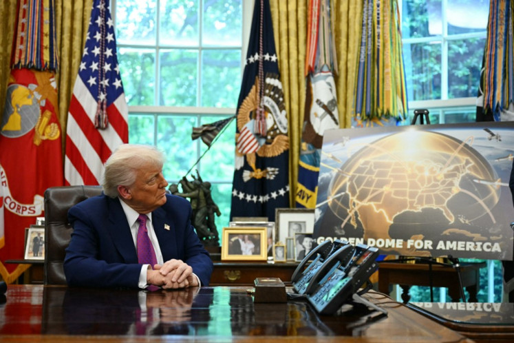 US President Donald Trump listens during an announcement about the Golden Dome missile defense shield, in the Oval Office of the White House on May 20, 2025, in Washington, DC.