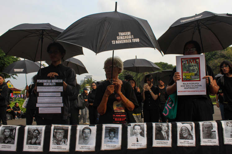 Sumarsih (center), an activist from the Victims Solidarity Network for Justice (JSKK), joins fellow demonstrators in the 861st Kamisan protest in front of the Merdeka Palace in Jakarta on May 15, 2025.