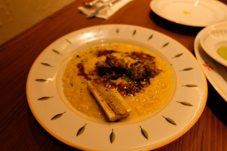Rich, cheesy and bold: Beef cheek risotto with saffron, a drizzle of jus and a crown of bone marrow.