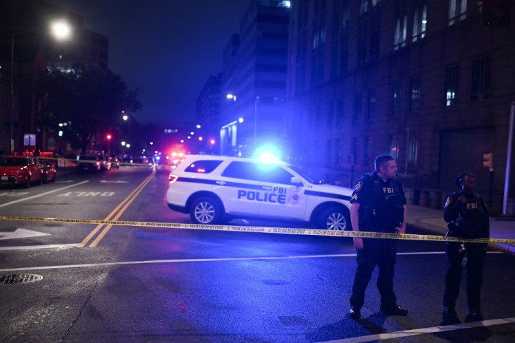 FBI agents cordon off the scene outside the Capital Jewish Museum following a shooting that left two people dead, in Washington, DC, in the early hours of May 22, 2025. 