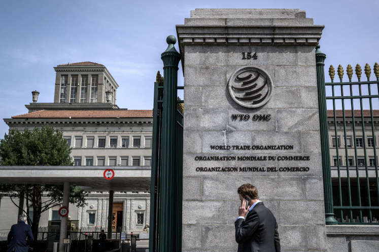 Point of reference: A man speaks on his phone while entering the World Trade Organization (WTO) headquarters on April 12, 2022, in Geneva, Switzerland.