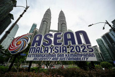 The logo of ASEAN's 2025 Malaysia's chairmanship is pictured on May 15, 2025, in front of Petronas Twin Towers in Kuala Lumpur.