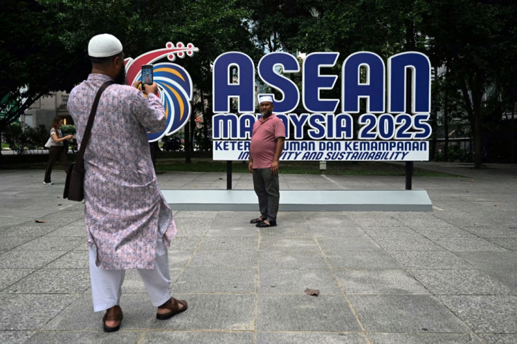 Critical voices healthy: Tourists take pictures on May 15, 2025 in front of the ASEAN Malaysia 2025 logo in Kuala Lumpur.