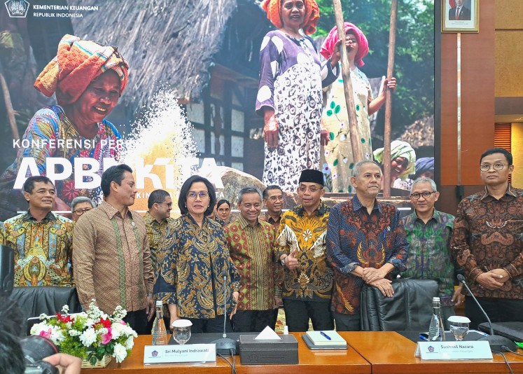 Customs and excise director general Djaka Budhi Utama (left) and tax director general Bimo Wijayanto (right) join in for a photo with the rest of the Finance Ministry's high-ranking officials in a state budget press conference called APBN-Kita held at the Finance Ministry's Jakarta headquarters on May 23.