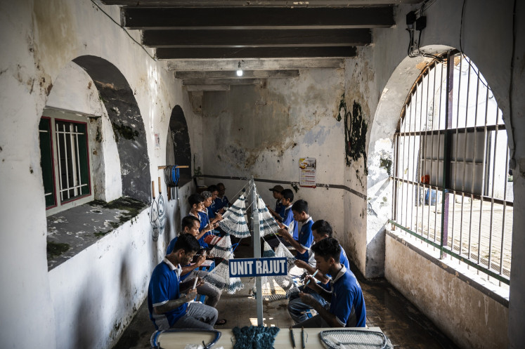 Inmates weave fishing nets at the Ambarawa Penitentiary in Semarang regency, Central Java, on May 14, 2025. The Ambarawa Penitentiary trains inmates to produce nets that are sold online as well as to fishing equipment distributors and fish farmers.