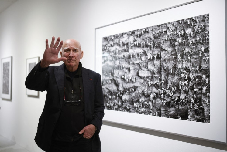 Brazilian photographer Sebastiao Salgado gestures as he stands in front of his work at the Bene Taschen gallery at his exhibition Gold in Cologne on Feb. 6, 2020. Brazilian photojournalist Sebastiao Salgado, who died on May 23, 2025, spent five decades chronicling the best and worst of planet Earth, from far-flung natural wonders to horrifying human catastrophes.