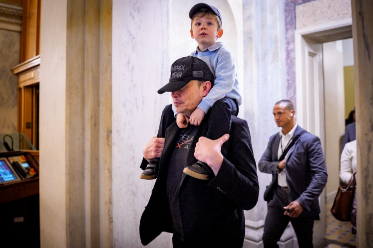 Elon Musk and his son leave a meeting with members of the Senate Committee on Commerce, Science and Transportation at the US Capitol building in Washington, DC, on May 21, 2025.