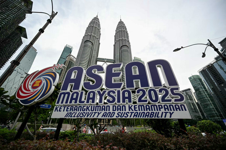 The logo of ASEAN is pictured in front of Malaysia's Petronas Twin Towers in Kuala Lumpur on May 15, 2025. Southeast Asian leaders will express deep concern over US President Donald Trump's tariff blitz when they meet at a summit on May 26, warning that the unilateral move posed huge challenges to economic growth and stability in the region, according to a draft statement seen by AFP.