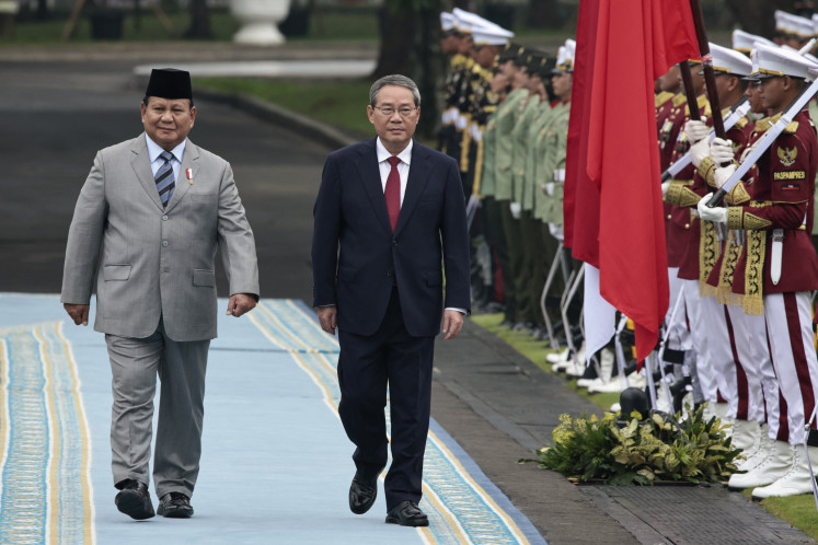 President Prabowo Subianto and Chinese Premier Li Qiang inspect a guard of honor during a welcoming ceremony at the Presidential Palace in Jakarta on May 25.