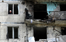 A local resident looks out of the window of his flat in a multistorey residential building, damaged following a Russian drone strike on Kyiv on May 24, 2025, amid Russian invasion in Ukraine. A massive Russian drone and missile attack on Kyiv on May 24, 2025, wounded at least 15 people, even as Russia and Ukraine continued the biggest prisoner swap since the start of Moscow's invasion.